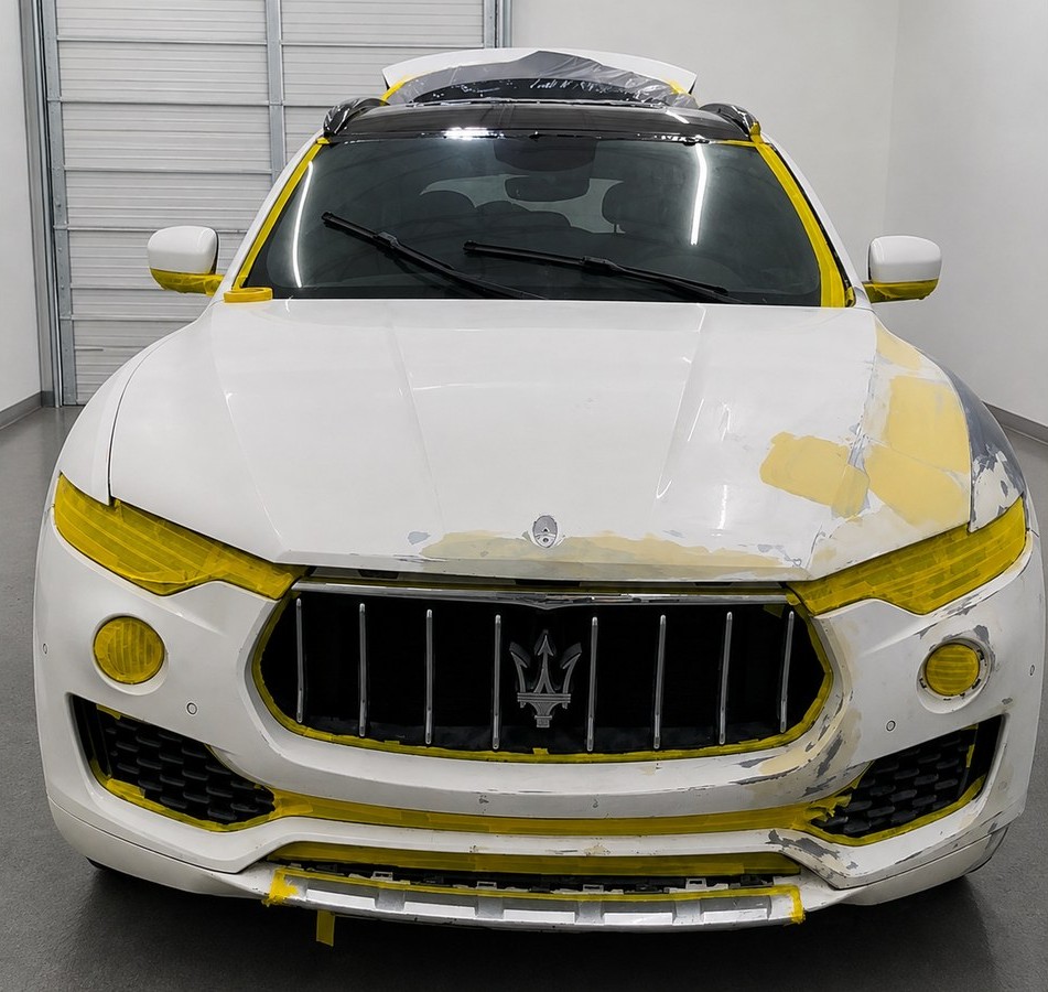 Maserati Levante front end stripped, filled and masked for refinishing at Total Care Collision, Pompano Beach FL