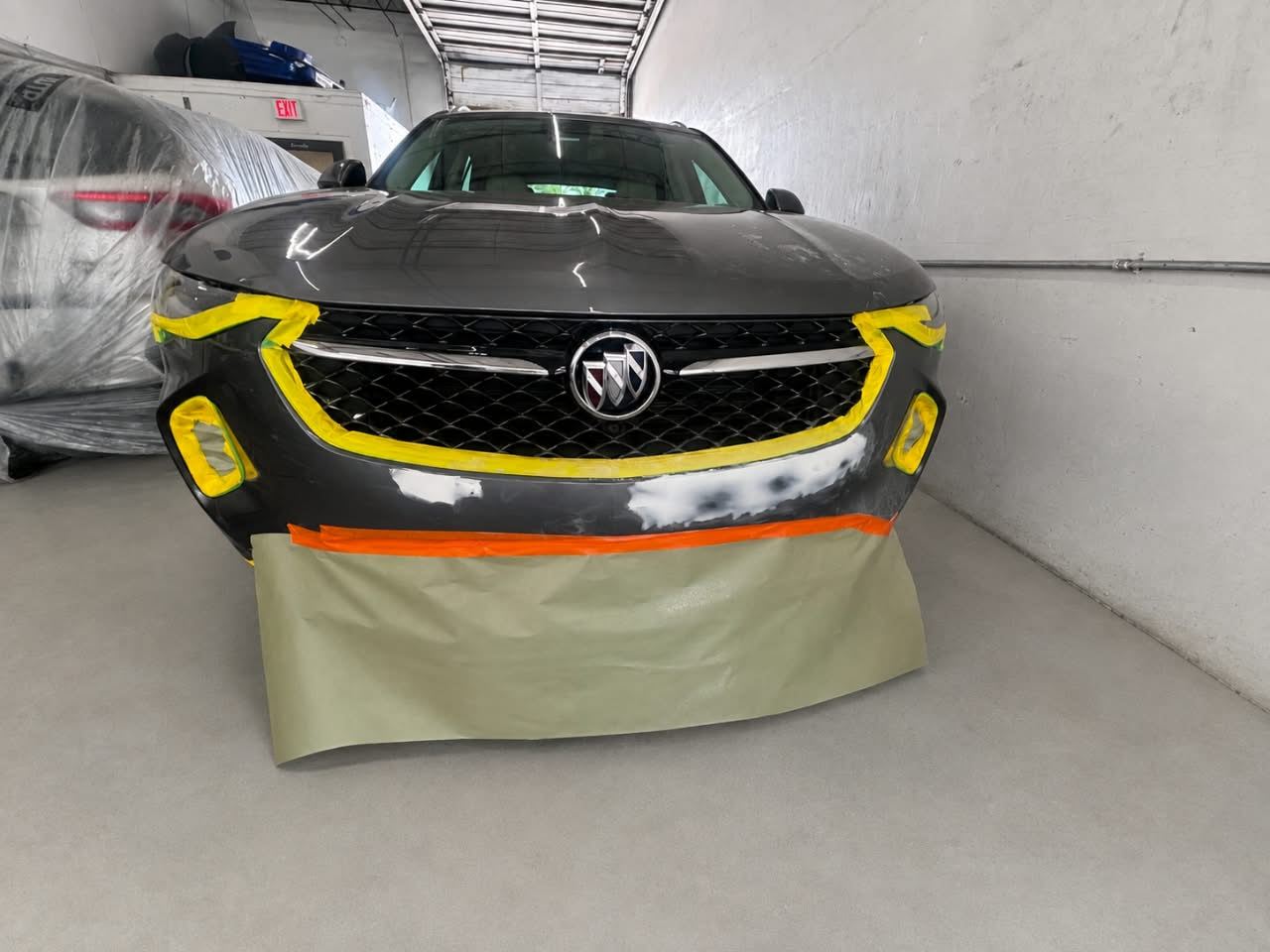 Grey Buick Envision with the front bumper masked for paint — Total Care Collision Pompano Beach FL